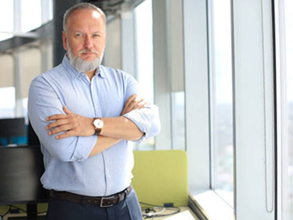 Confident pensive mature business man in modern office